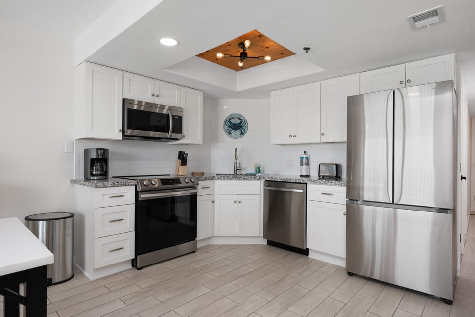 Fully stocked kitchen area with stainless steel appliances