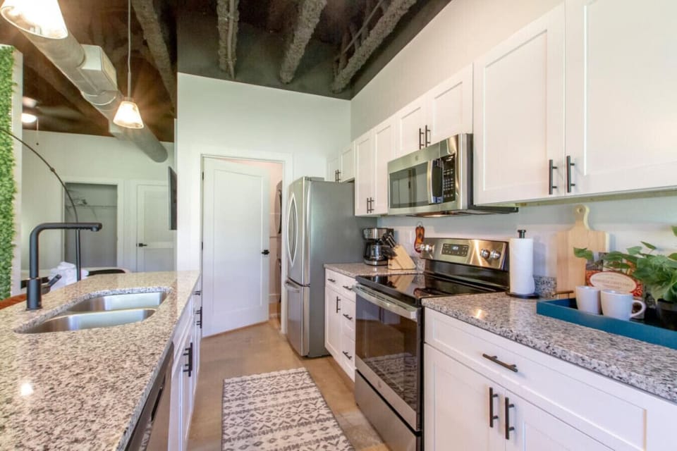 Kitchen view toward the entryway showing clean lines and a well-appointed, functional layout