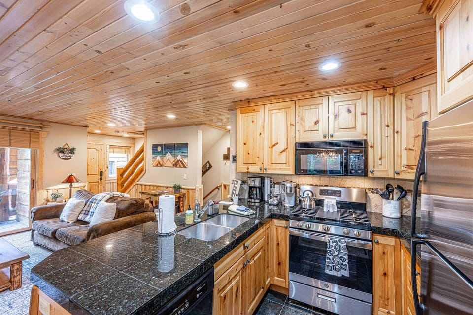 The fully stocked kitchen flows seemlessly to the living room of the home and has everything you need for a meal at home