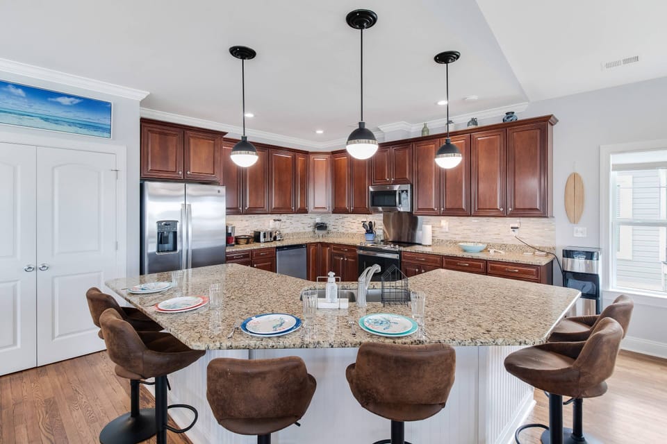 The Large Kitchen Island not only seats 6 but is Additional Prep Space & a Spot to serve from a Buffet Style Meal.