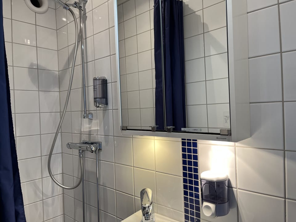 Shower, hair dryer, towels, toilet paper