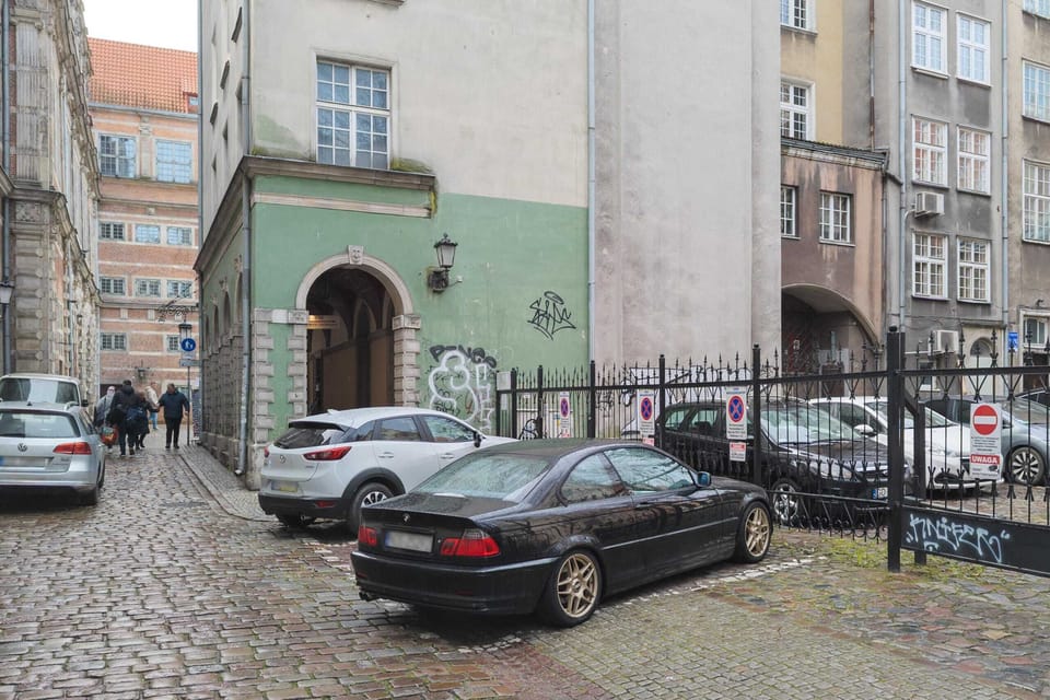 Secure courtyard with parking space, blending historical charm with modern functionality.
