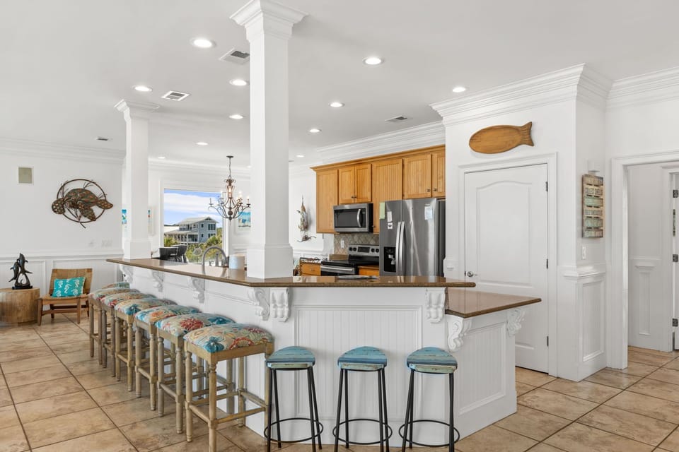 Gather at this welcoming kitchen, where you'll find a spacious island with seating for everyone, granite countertops, and modern appliances ready for your culinary adventures.