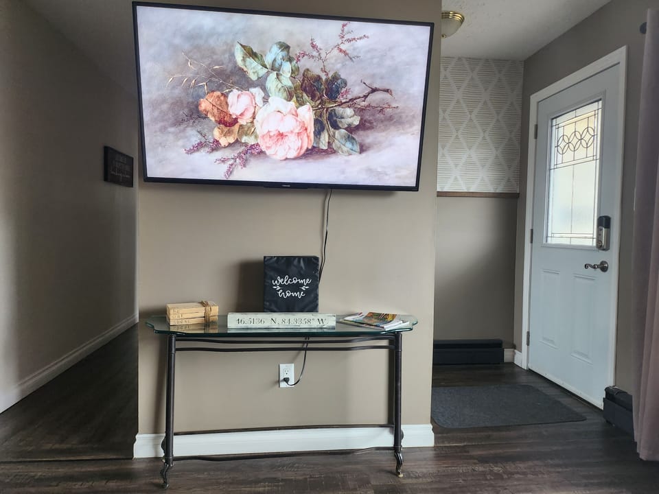 Enterance of the home and partial living room. Hallway to bedrooms/bathroom.