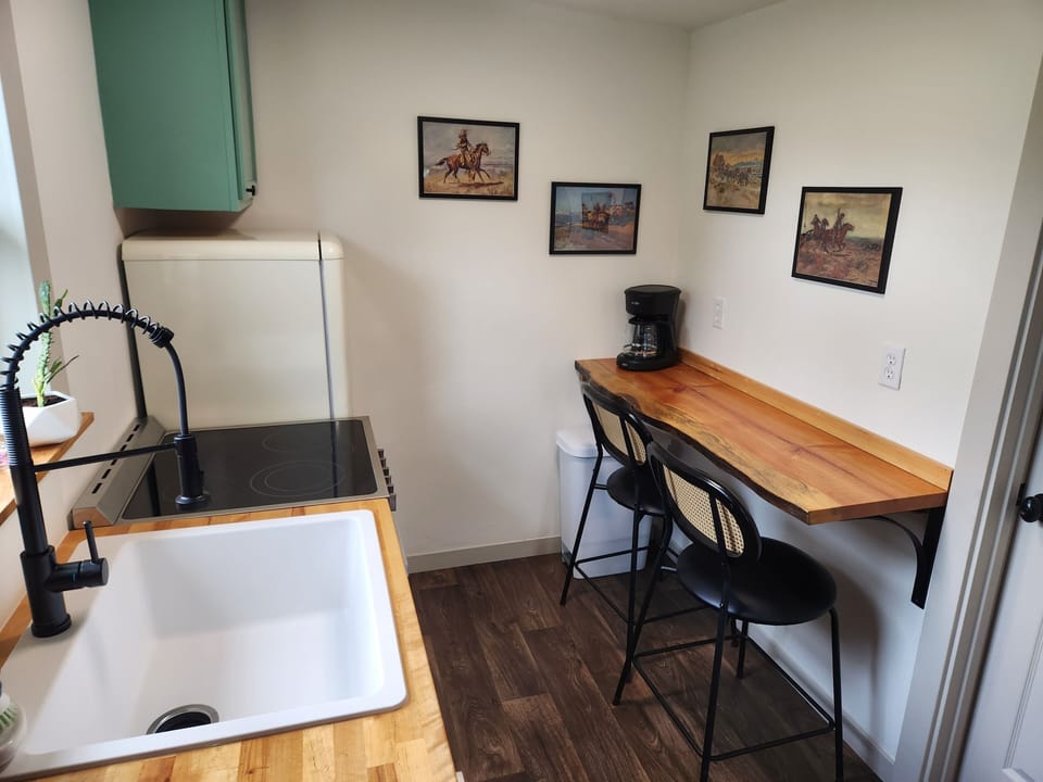 Kitchen: stools, live edge bar, coffee & tea, garbage disposal, pots and pans
