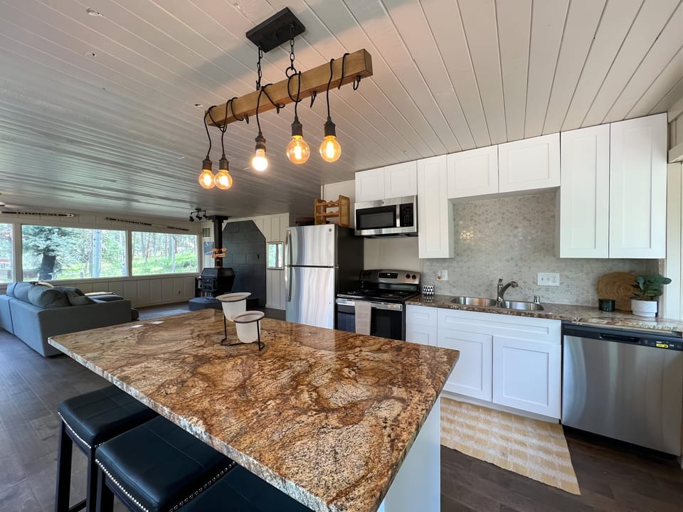 Open concept kitchen newly remodeled with granite counters and stainless applian