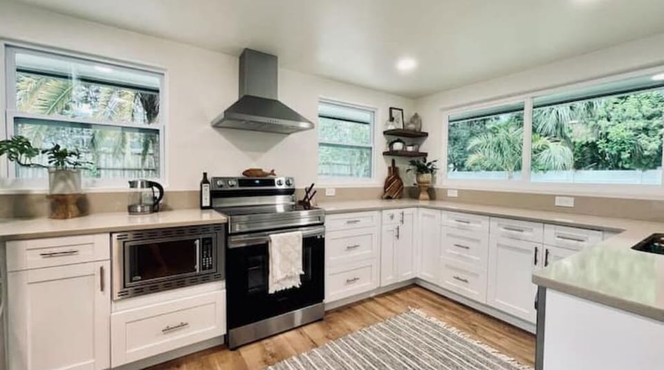Fully renovated kitchen with new cabinets, countertops, appliances and windows.