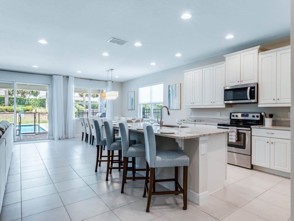 - Bright open kitchen with stainless steel appliances and island seating  
- Orlando vacation rental with pool view and family dining space  
- Spacious home near Disney designed for comfort and gatherings