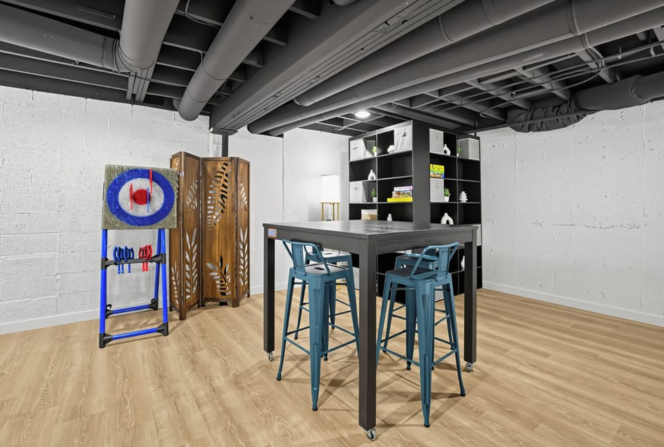 Kick back in the game room with foosball, a large-screen TV, lounge seating, and a high-top table for snacks, games, or drinks.