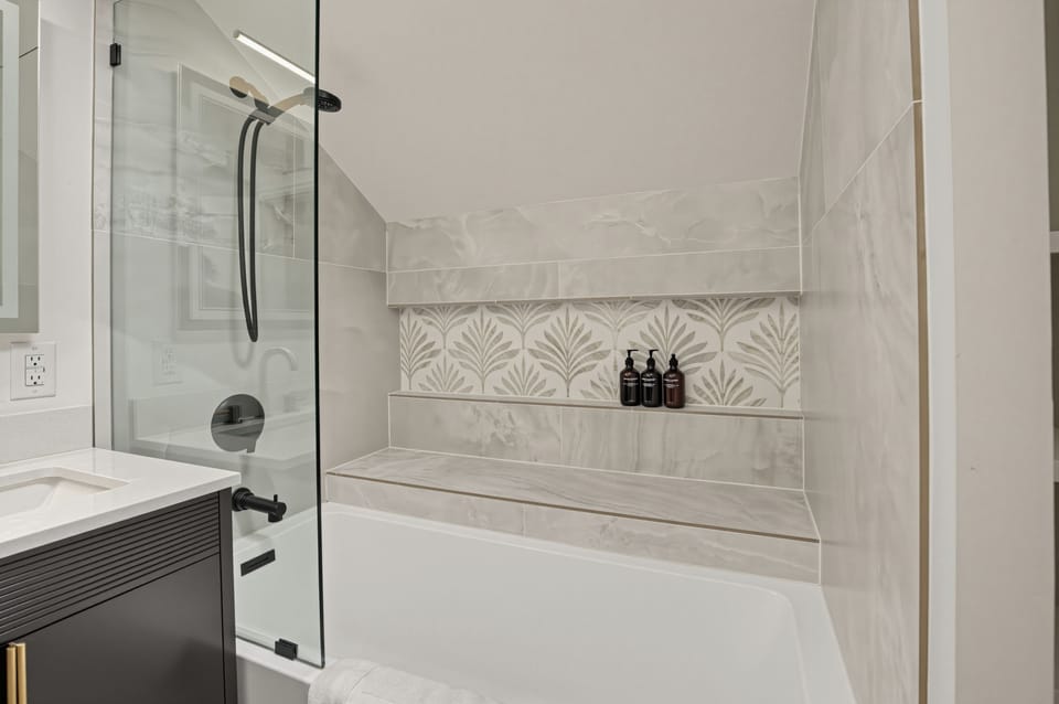 Primary bedroom's ensuite features a shower/tub combo.