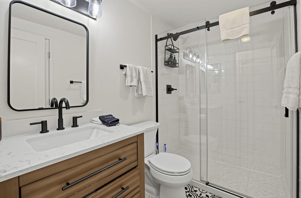 Bedroom 2's ensuite features a shower and is also accessible through the hallway.