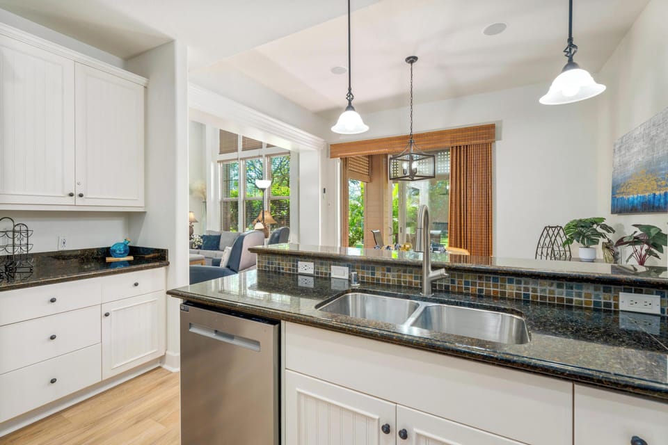 You'll love cooking in this bright, open kitchen with granite counters, pendant lighting, and views of the lush garden beyond.