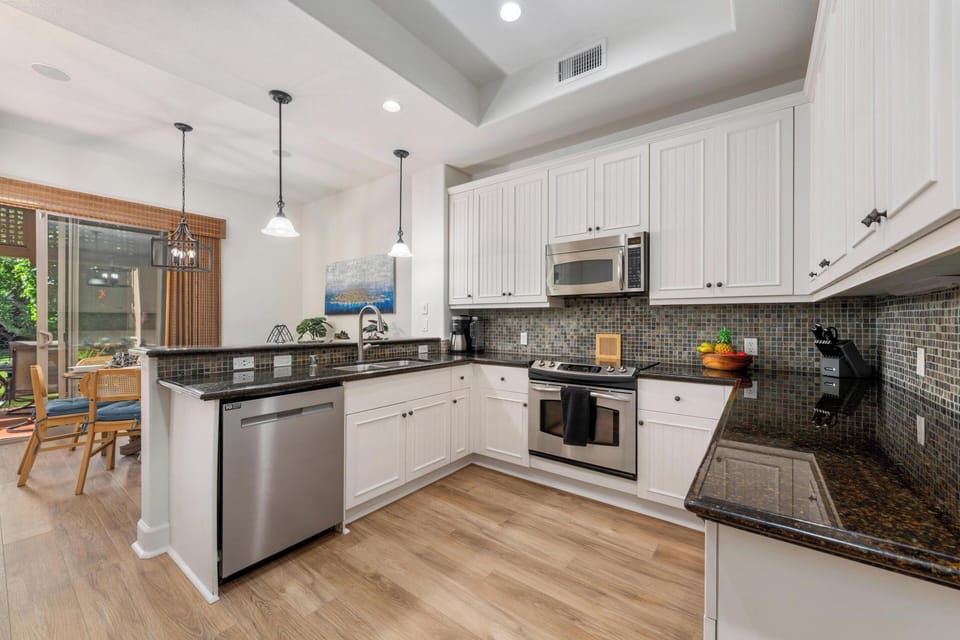 Your spacious kitchen features granite countertops, stainless appliances, and elegant pendant lighting—perfect for preparing memorable meals together.