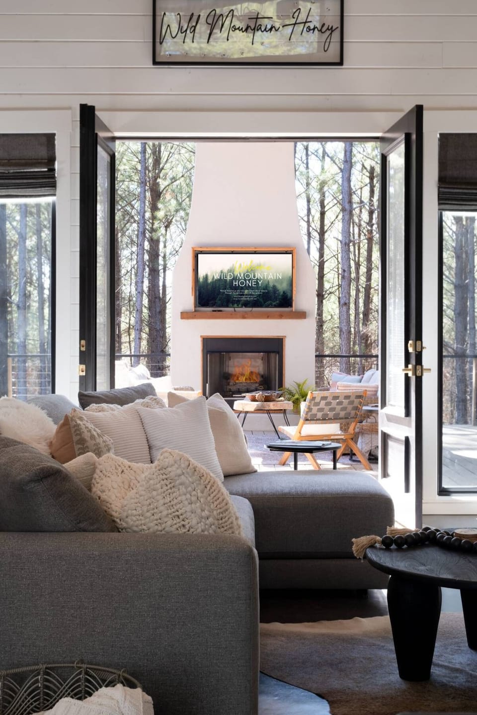 Bring the outdoors indoors in🪑 Plenty of seating & dining 🪟 Handy service window 🔥 Cozy fireplace & soothing hot tub 🌀 Built-in fans & Bluetooth speakers 🍔 Dual BBQ grill.