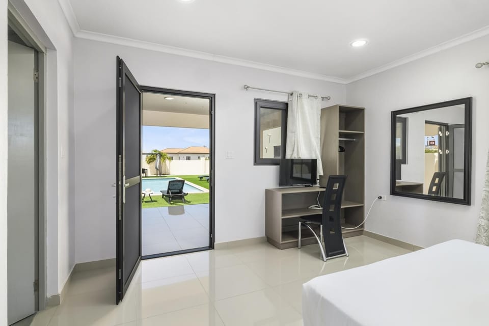 Feel comfortable with an air-conditioned bedroom, wooden headboard and cozy mattress, large mirror and a sofa.