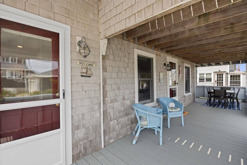 1st floor covered wrap around porch with lounge furniture and outdoor dining table set.  Depending on where you're sitting, you'll have ocean or marsh