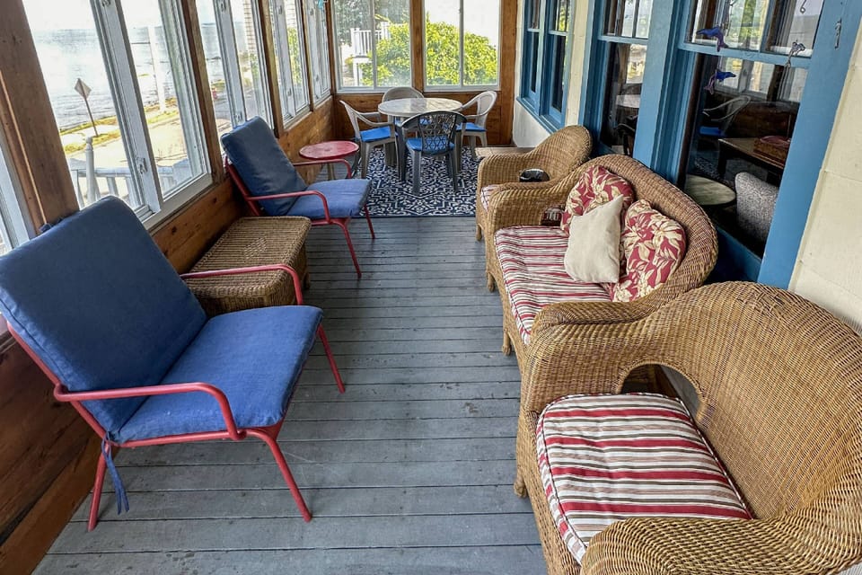 Various seating options on ocean-facing front screened porch