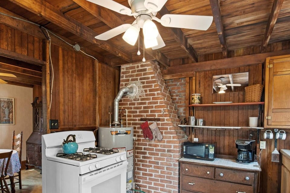 Fully equipped kitchen with microwave, coffee maker, toaster, tea kettle, and all the other items you need to have a summer family dinner