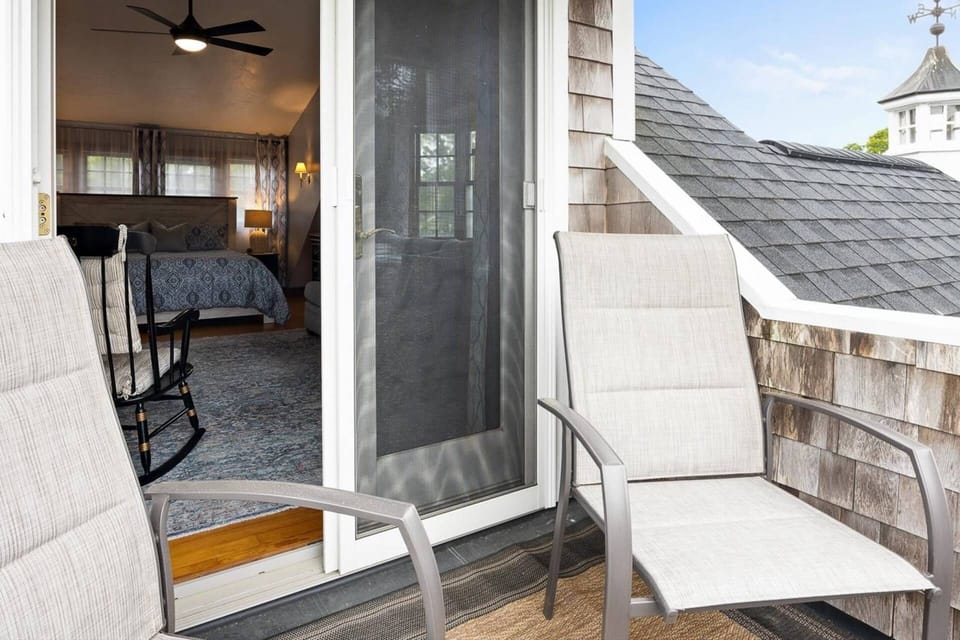 View from private balcony seating area into King bedroom with queen-size sleeper sofa
