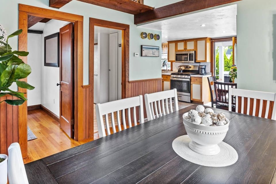 View of dining area, queen bedroom, full bathroom with shower stall, and kitchen