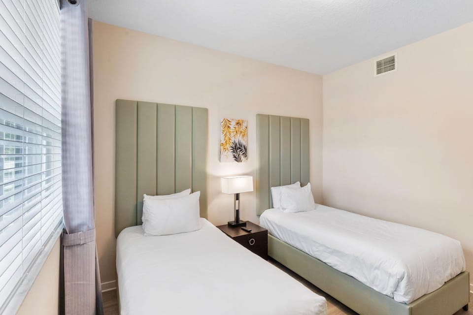 Cozy Comfort: Bedroom 3 offers ample space and features two beds, perfect for a restful night's sleep.