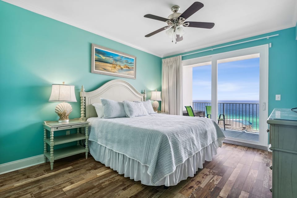 Relax in this coastal bedroom with ocean views and a balcony seating area.
