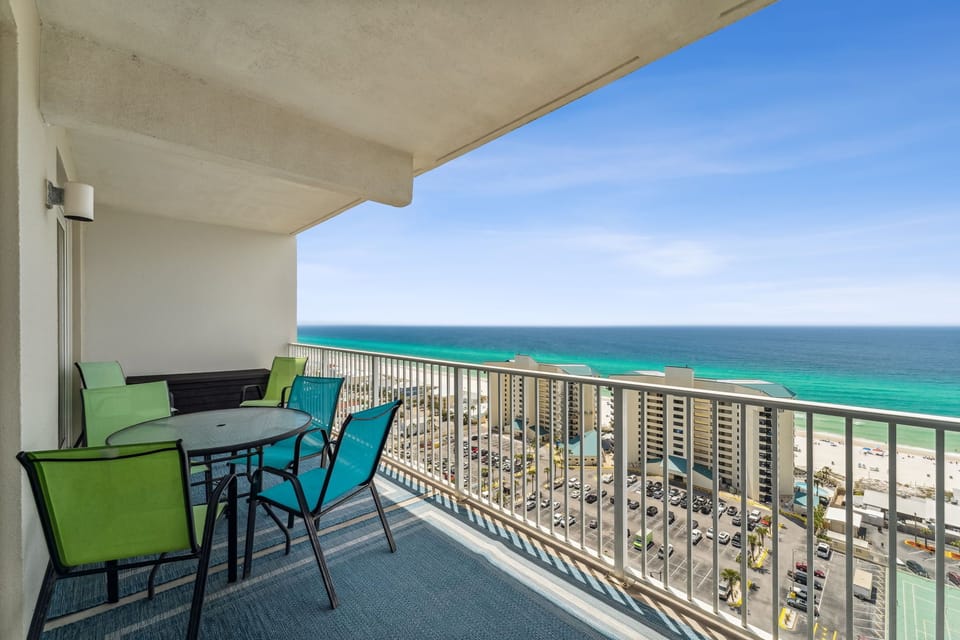 Relax on the balcony with panoramic ocean views and outdoor seating.