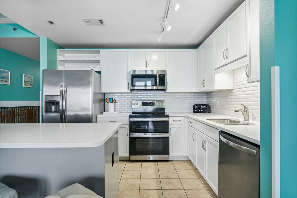 Modern kitchen with stainless steel appliances and white cabinetry