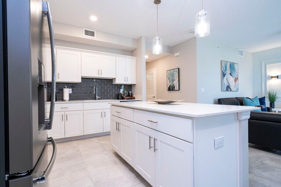 The fully equipped kitchen features modern appliances, sleek cabinetry, and all essential cookware and utensils, making it perfect for preparing meals with ease.