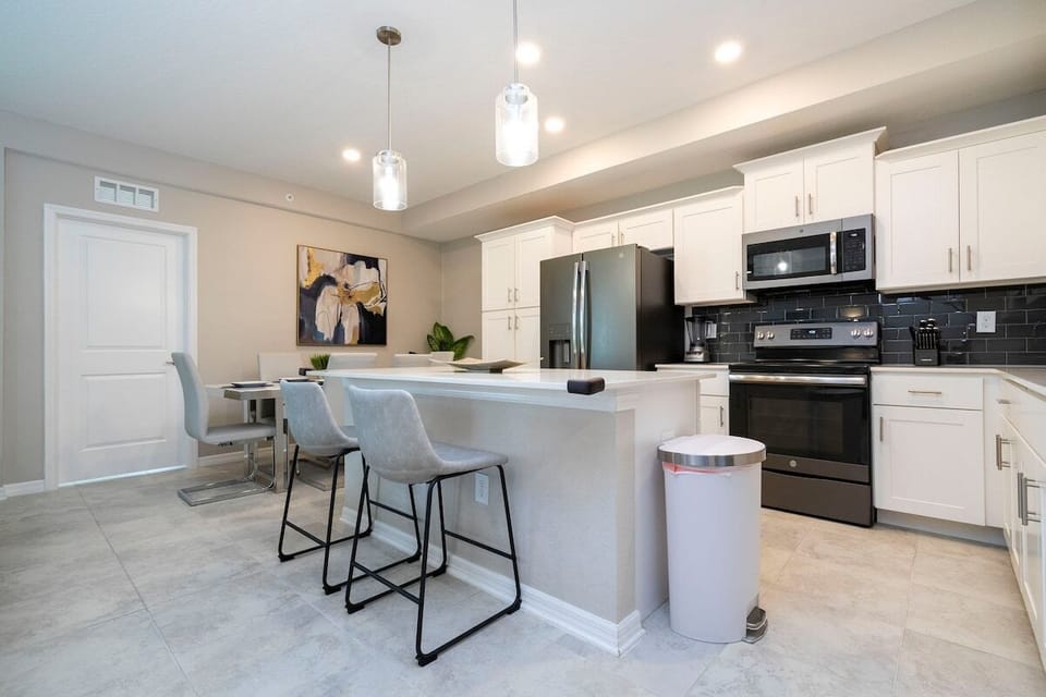 The fully equipped kitchen features modern appliances, sleek cabinetry, and all essential cookware and utensils, making it perfect for preparing meals with ease.