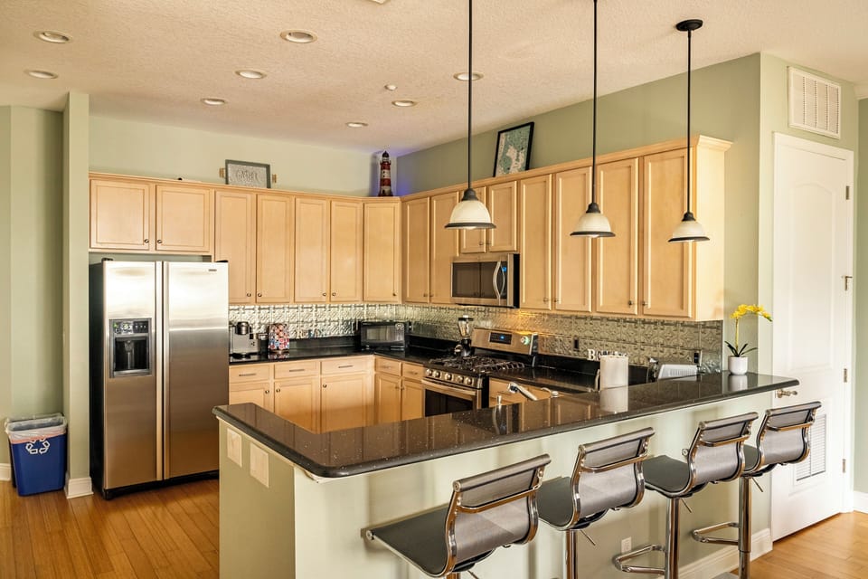 Big kitchen with bar and chairs