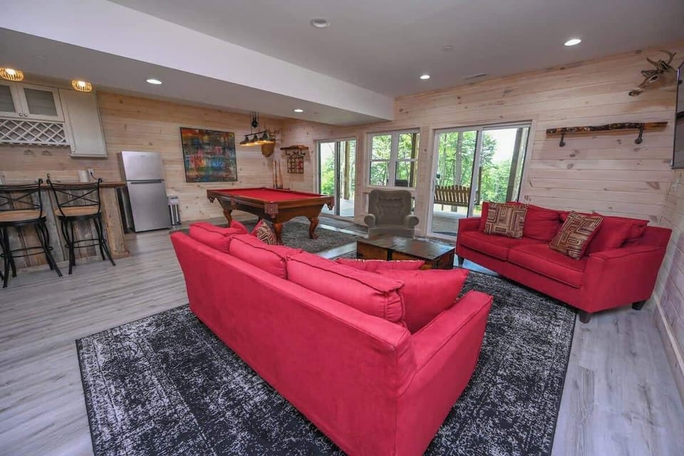 Lower Level Rec room.  TV, Walk-out, Sofa couch, pool table, and wet bar with small refrigerator and a wine/beer fridge.