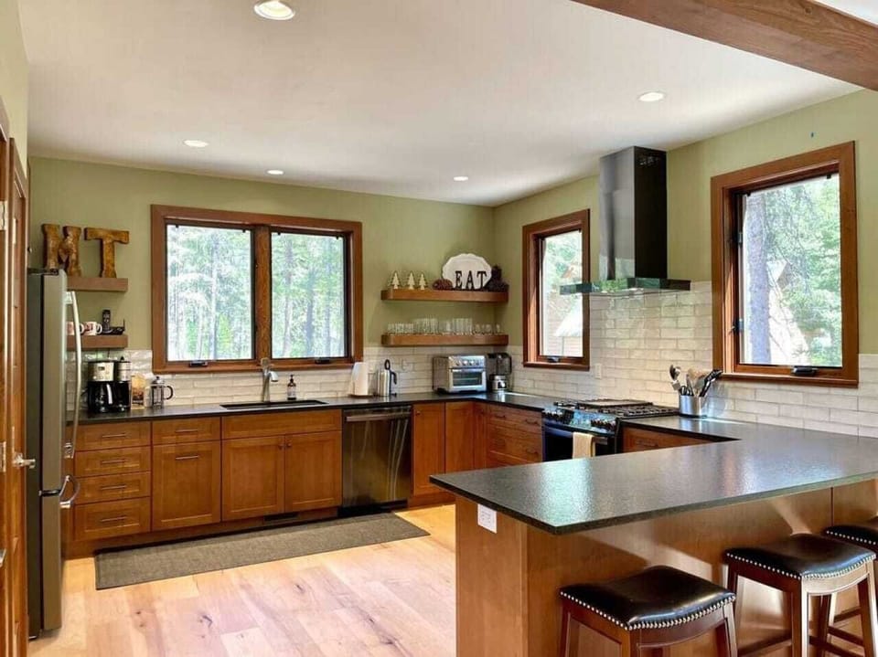 Large open kitchen with gas range and new stainless appliances