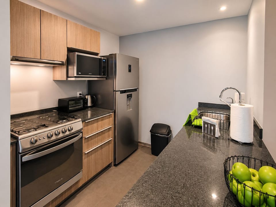 The kitchen is fully equipped with modern appliances and utensils, ensuring you have everything you need for cooking and preparing meals during your stay.