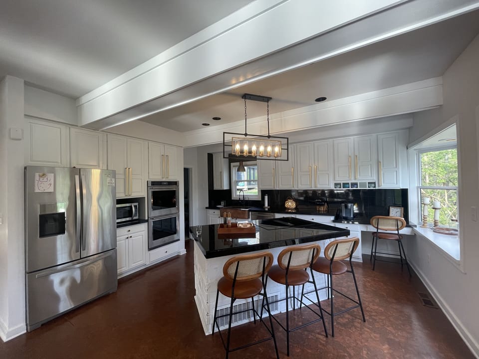 large kitchen with stove, double oven, and keurig