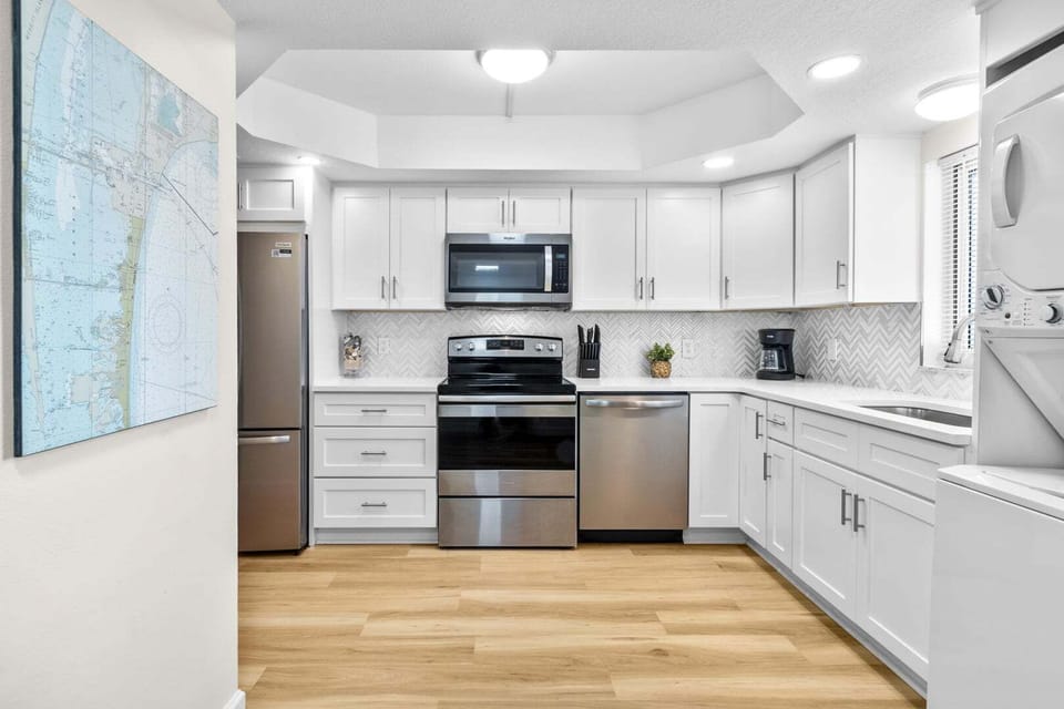 Fully equipped kitchen with wooden cabinetry and sleek modern appliances