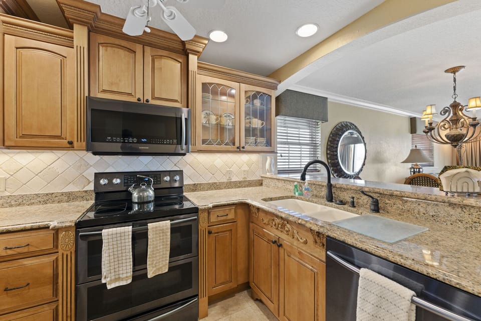 Fully equipped kitchen with modern appliances and ample counter space for cooking.