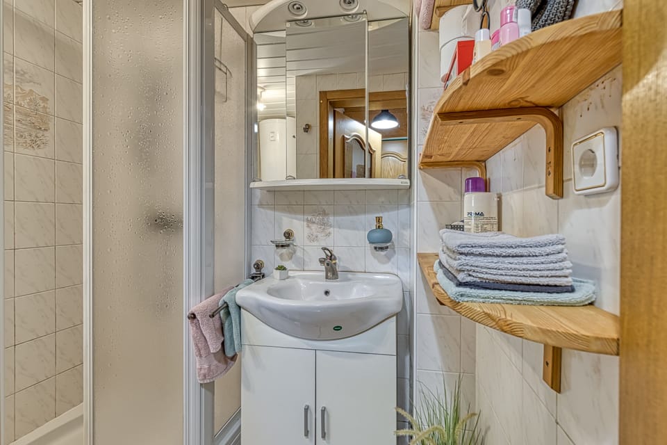 Bathroom with shower and single vanity
