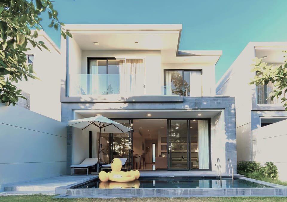 A view of Villa's exterior from the backyard, with a vista of BRG golf course. 