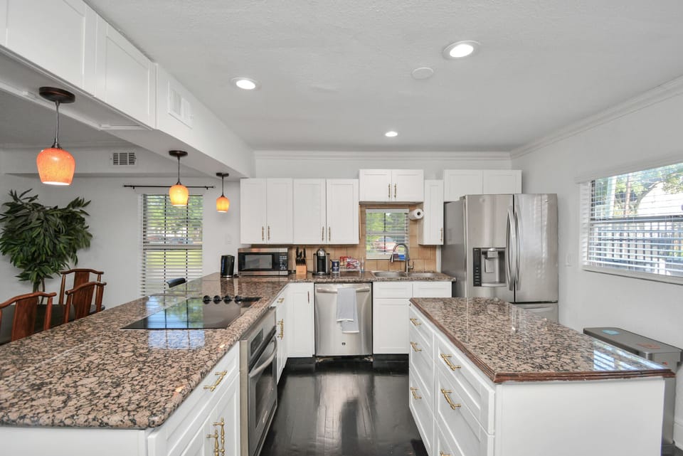 Full-sized kitchen with stainless steel appliances, coffee, tea, and spices 