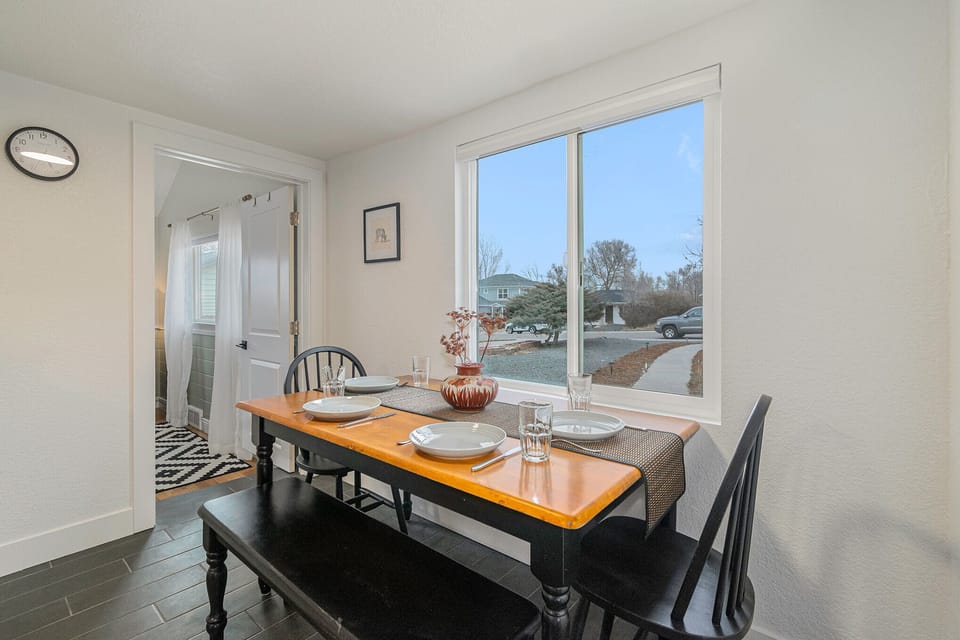 - Enjoy breakfast or dinner at this timeless wood dining table that seats four
- Bask in the natural light and enjoy calming views of the quiet neighborhood
- Ideally positioned with simple access to the kitchen, hallway, and nearby bath