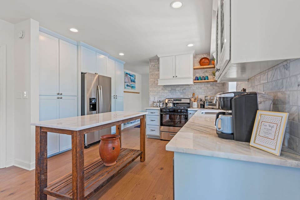 Thoughtfully designed kitchen featuring a large island, modern appliances, and plenty of counter space, making it easy to prep, serve, and gather with your group.
