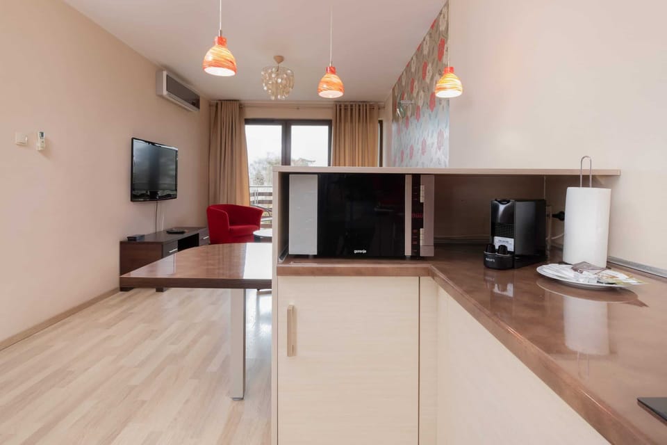 A close-up of the kitchen counter, showing a coffee machine, kettle, and other essentials.
