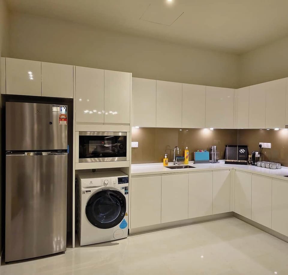 A full feature kitchen inclusive of 2 zones induction  cooker, full height refrigerator, microwave with grill function, plenty of storage cabinets and a wash basin. Washing machine with heater is also available here.