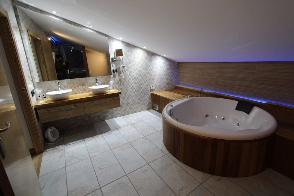 Luxury Studio Suite | Bathroom | Designer toiletries, hair dryer, bathrobes, towels