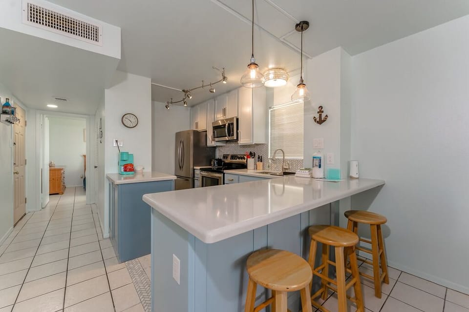 Our fully equipped kitchen has a breakfast bar with 5 stools. It's a sweet little spot to keep the kids entertained.
