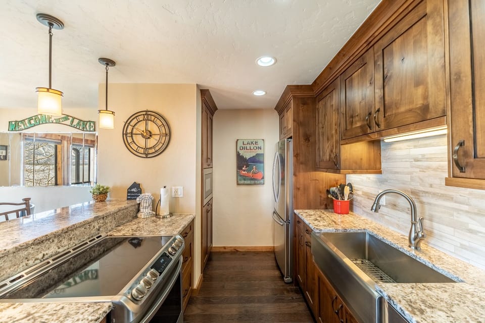 Your fully-equipped kitchen welcomes you with warm wood cabinets, granite counters, and modern appliances—perfect for preparing memorable meals during your stay.