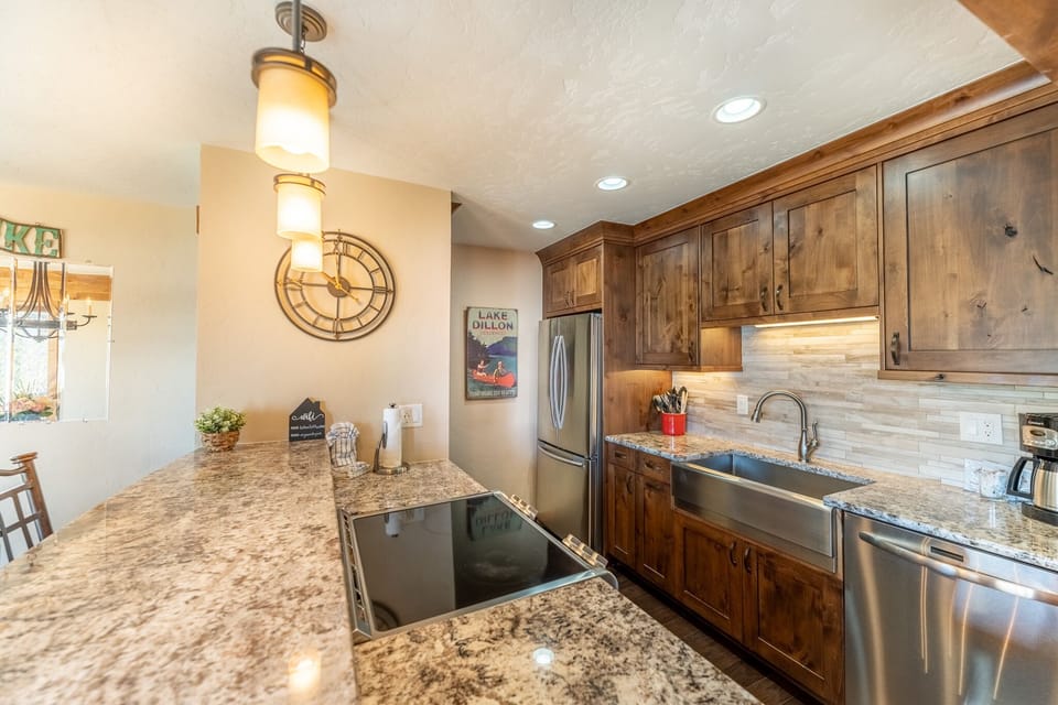 Your gourmet kitchen awaits with granite counters, rich wood cabinets, and stainless steel appliances perfect for creating memorable meals together.