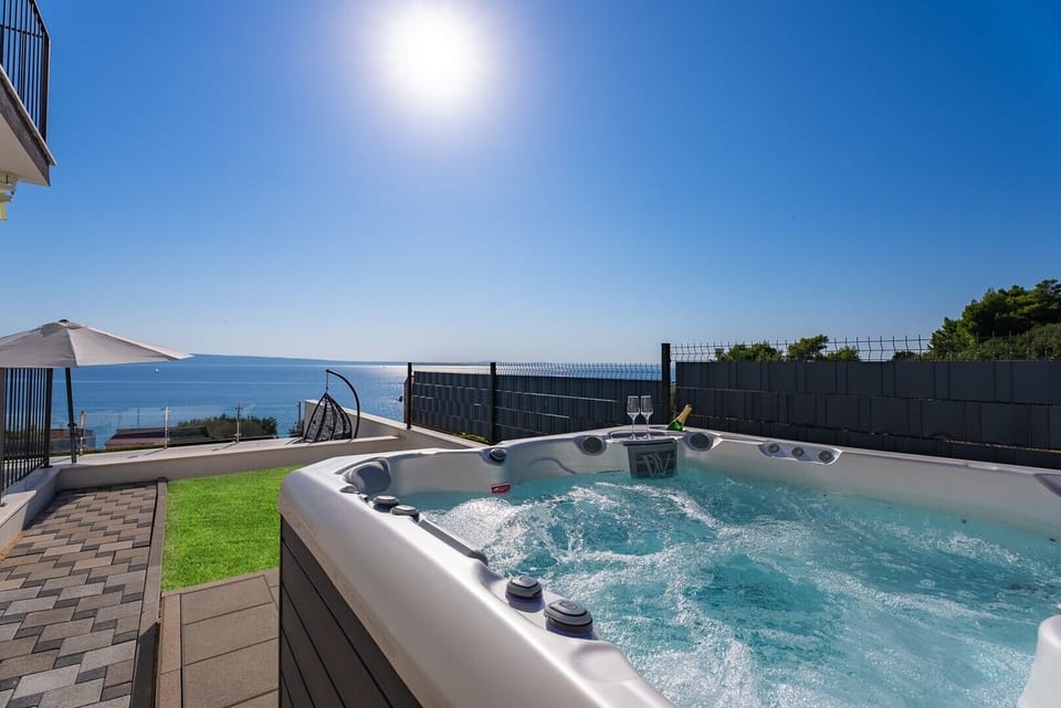 A Hot-Tub (a Whirlpool) next to the covered outdoor dining area (a few steps above the pool and sundeck)
