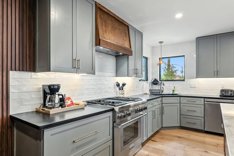 Kitchen: Drip coffee maker, Crockpot, blender, cooking utensils, tableware
